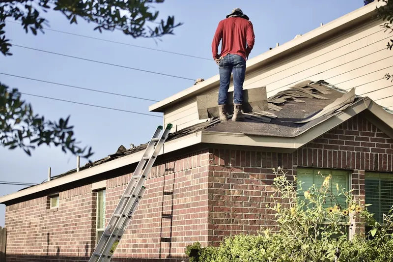 Professional roofer working on a residential roof in Golden Ring Camp